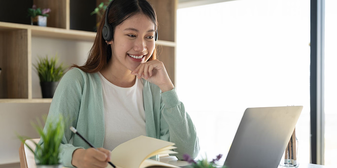 woman smiling at computer in a telehealth call