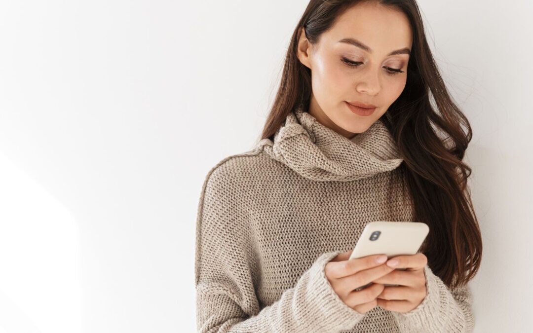 woman in beige sweatshirt on phone looking at abortion options