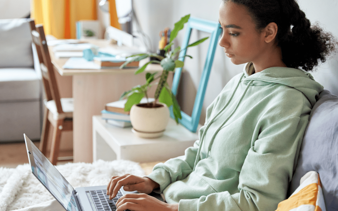 teenage girl looking at pregnancy information on laptop