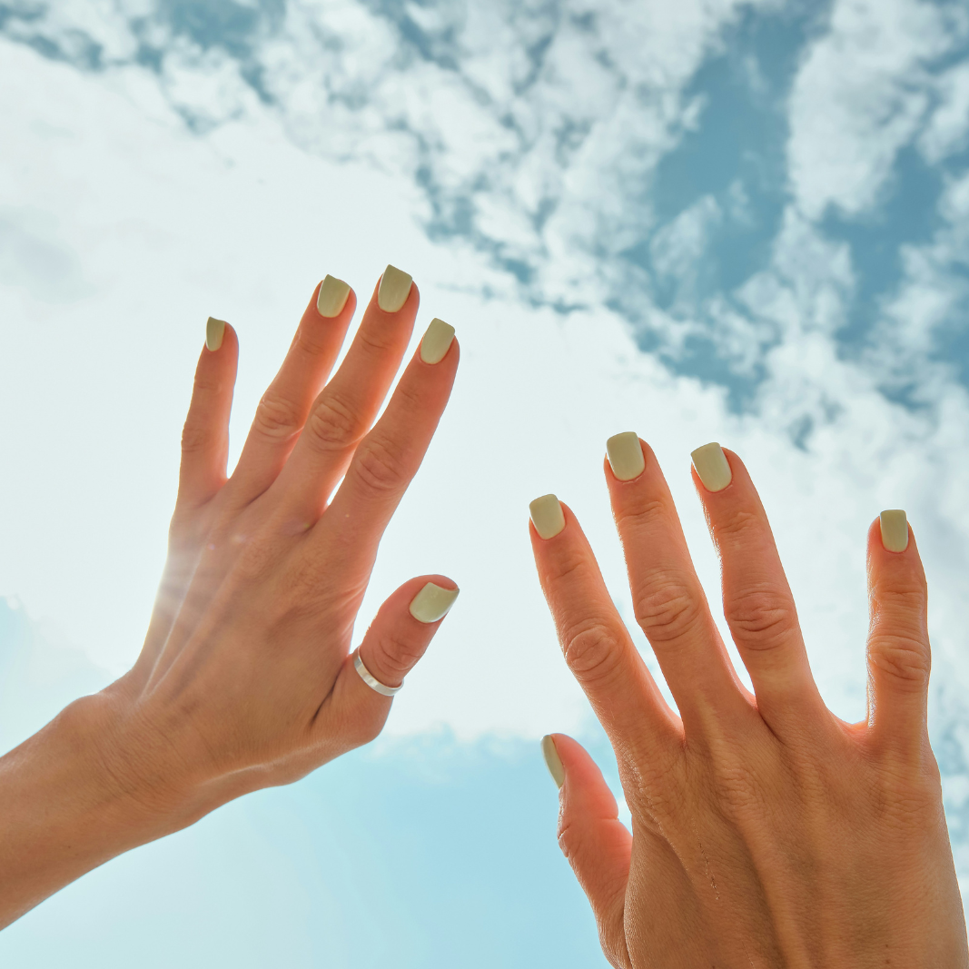 woman's hands up in sky